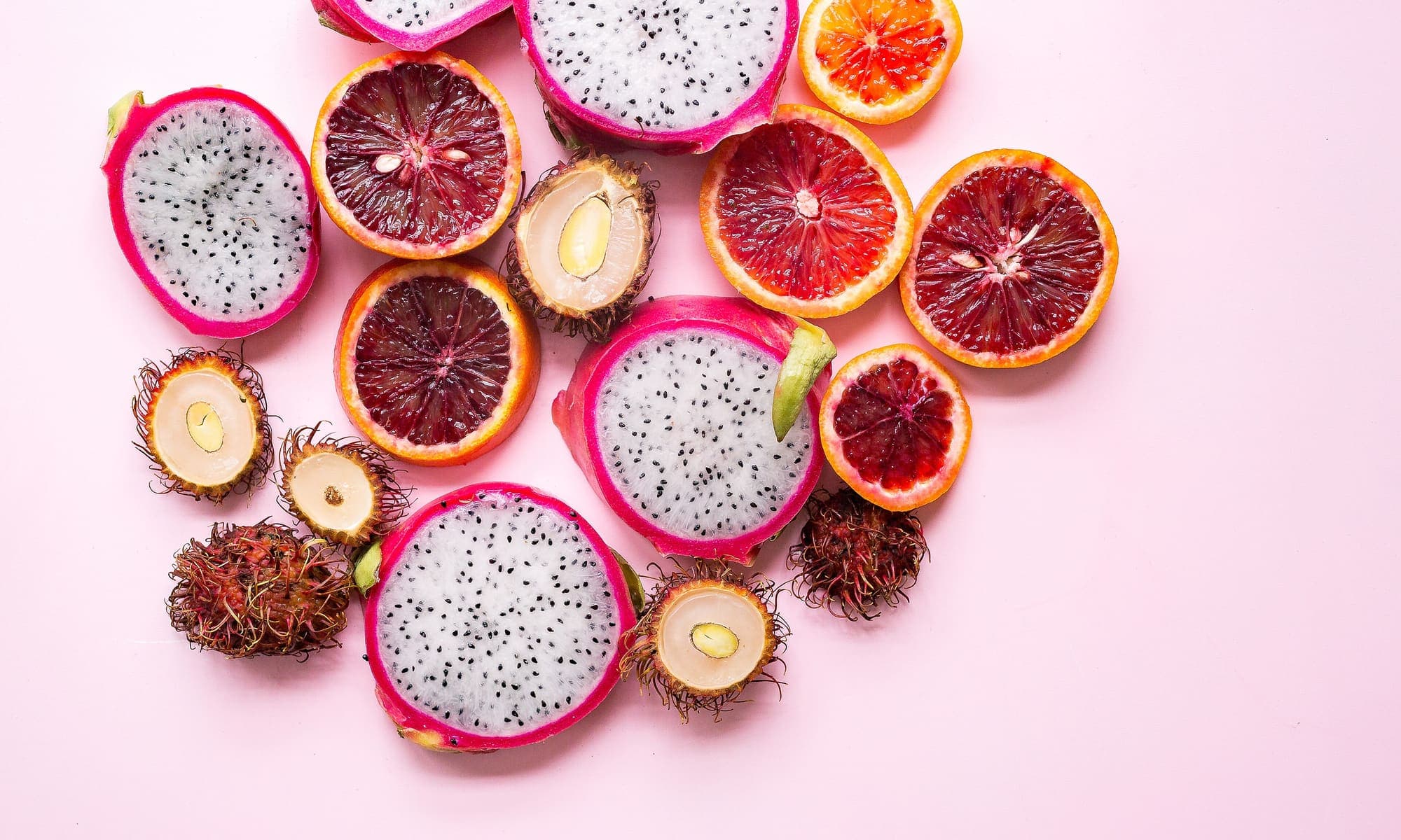 Pink-skinned dragon fruit, whole and halved